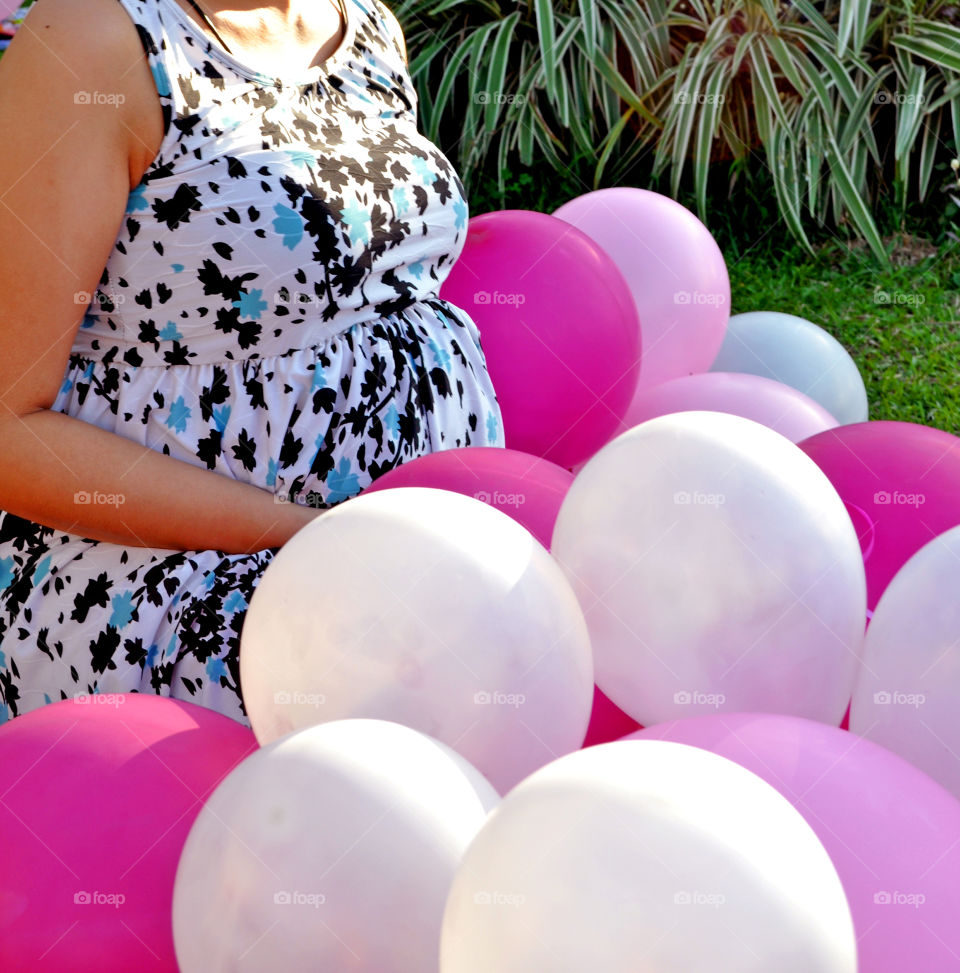 Ready to pop, preggy, pregnant woman with pink balloons