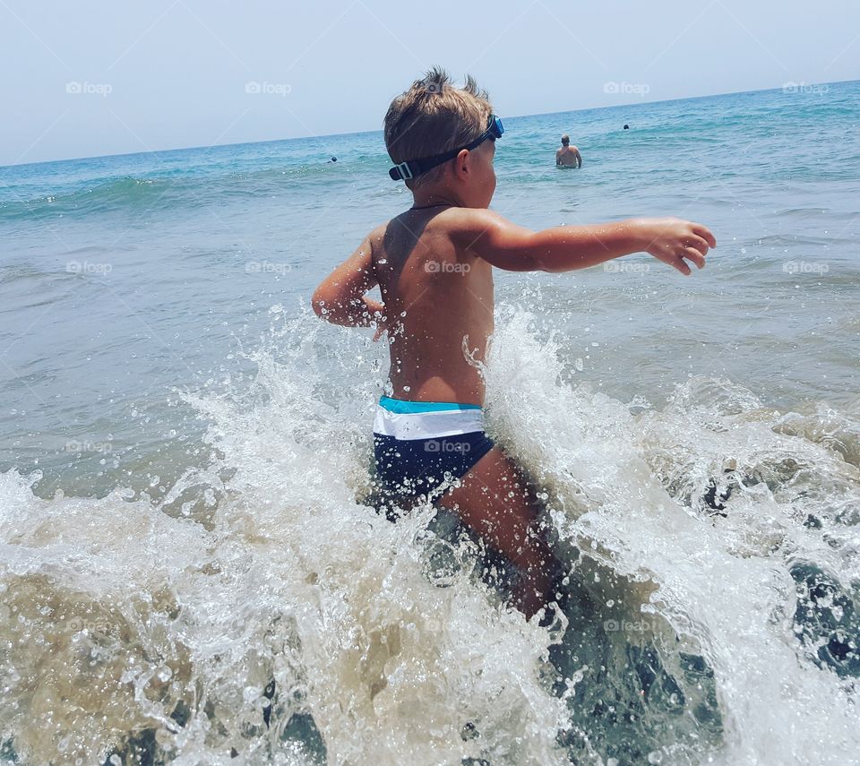 Boy and big waves in the ocean