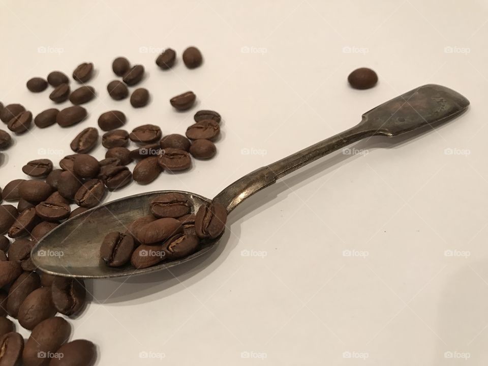 Coffee beans and silver spoon