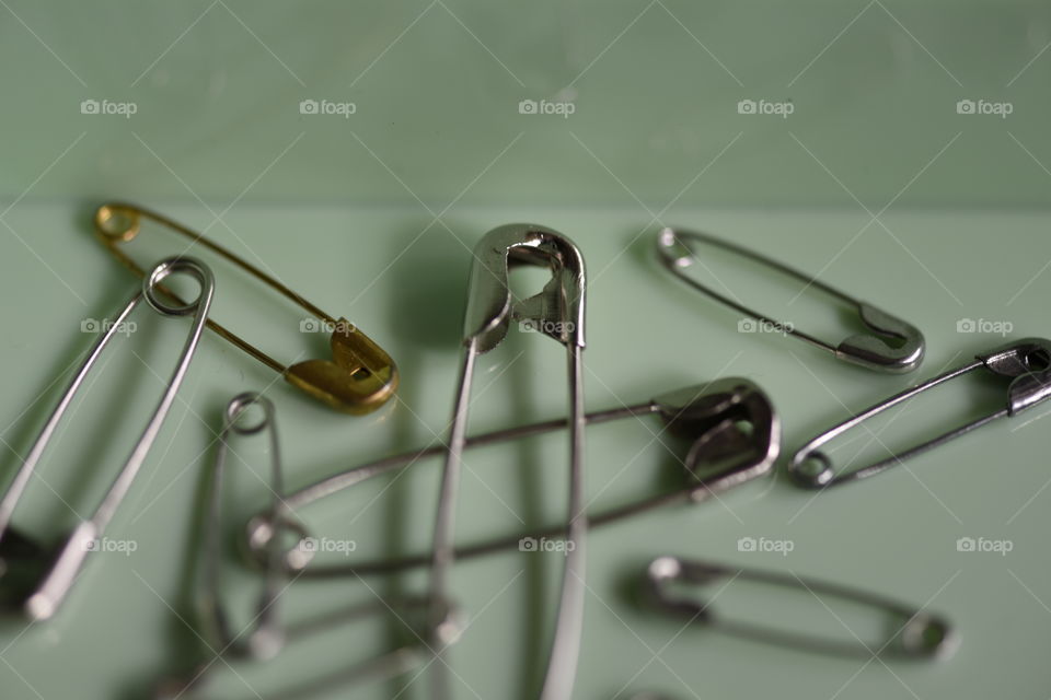 Safety pins made of stainless steel and brass.