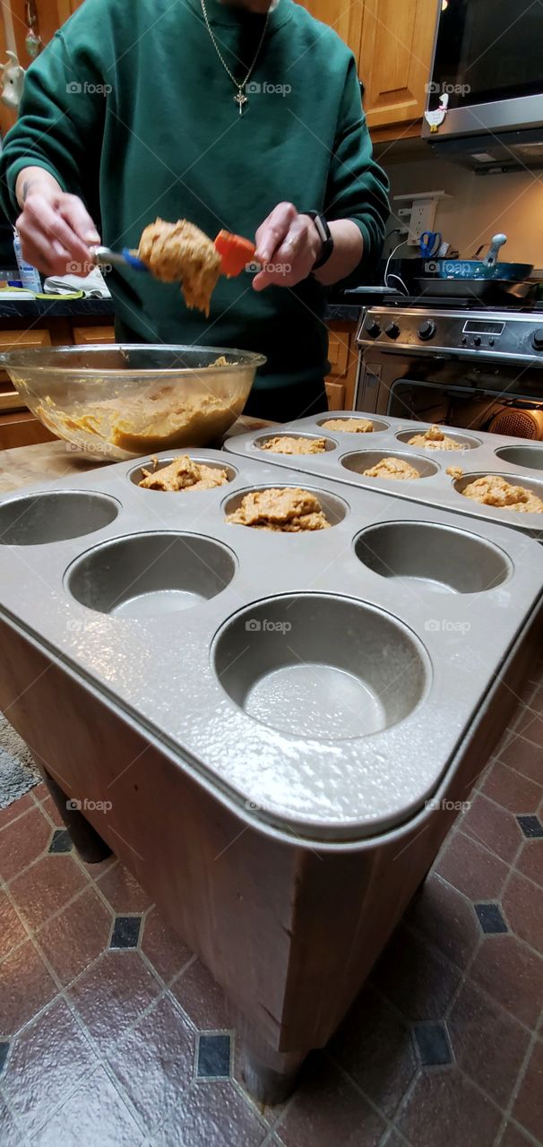 #stayathome-cooking. Making homemade muffins , filling muffin pans with batter. Stove door open & waiting.