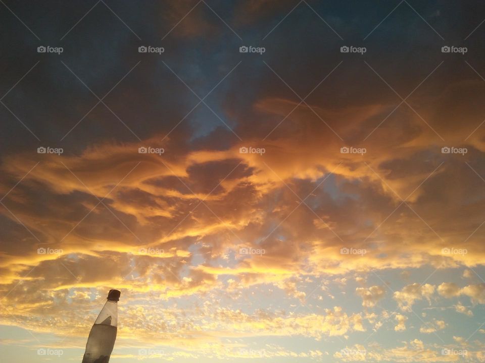 Scenic sky and a bottle embraces high sky.