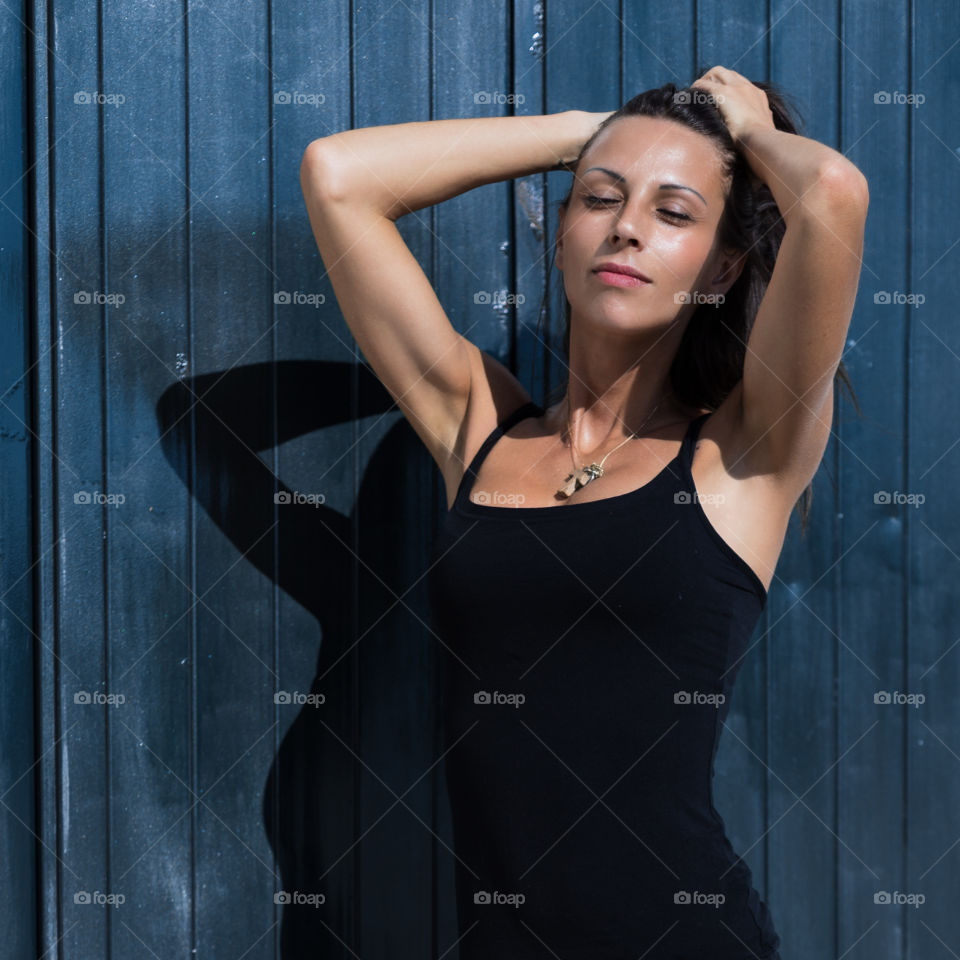 Beautiful woman posing against wall