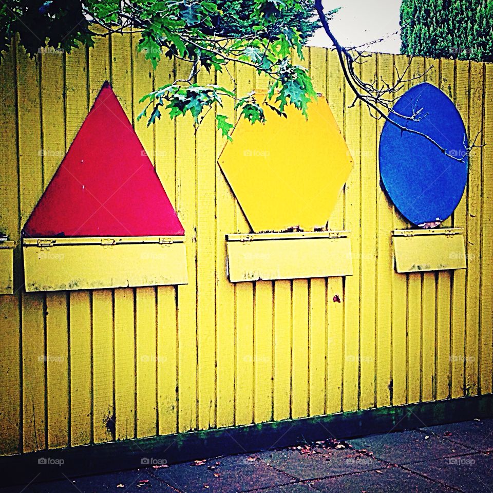 Colourful learning shapes along fence 