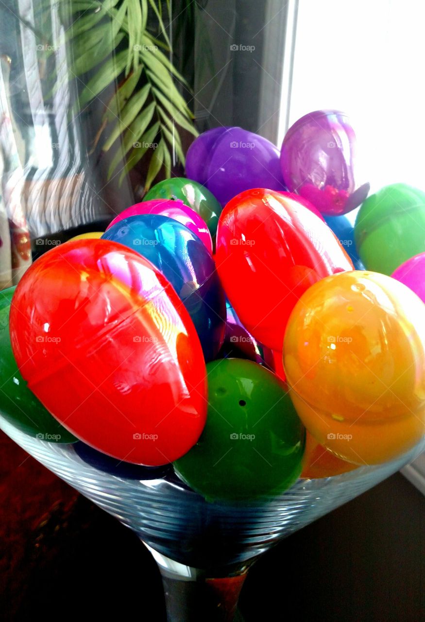 multicolored plastic Easter eggs glass bowl