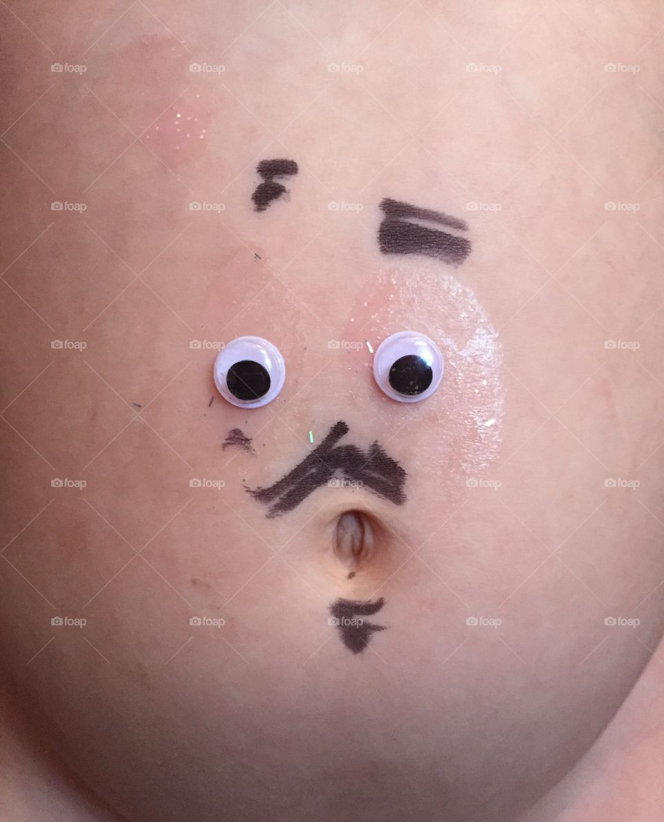 Googly eyes, and goofy face on a toddlers belly. 