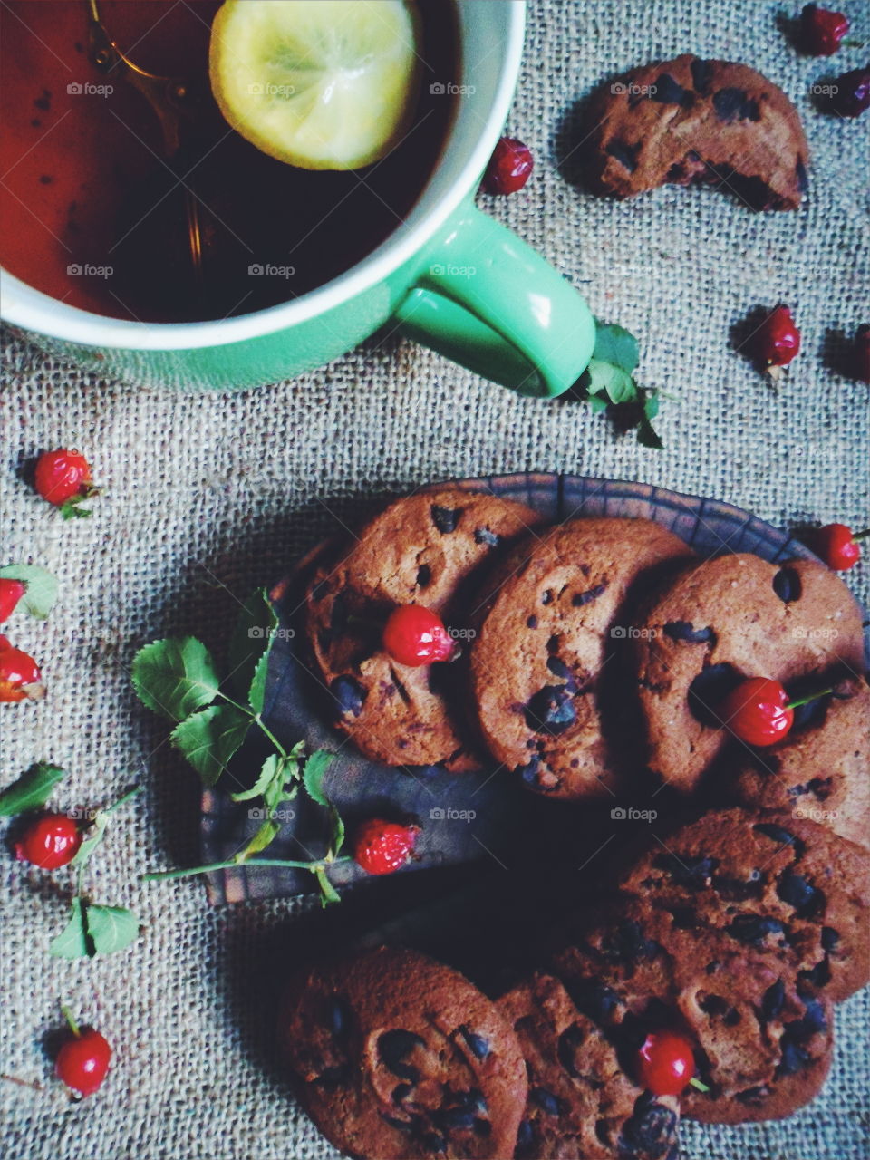 oatmeal cookies with chunks of chocolate and a cup of tea, dessert