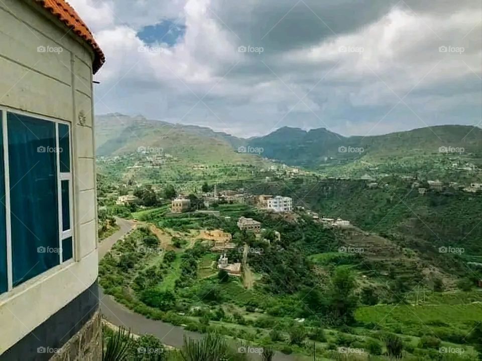 A stunning view of green mountains covered in fog in Yemen