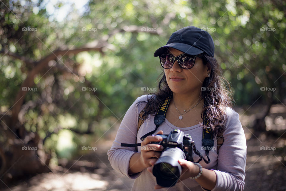 woman with camera in the forest