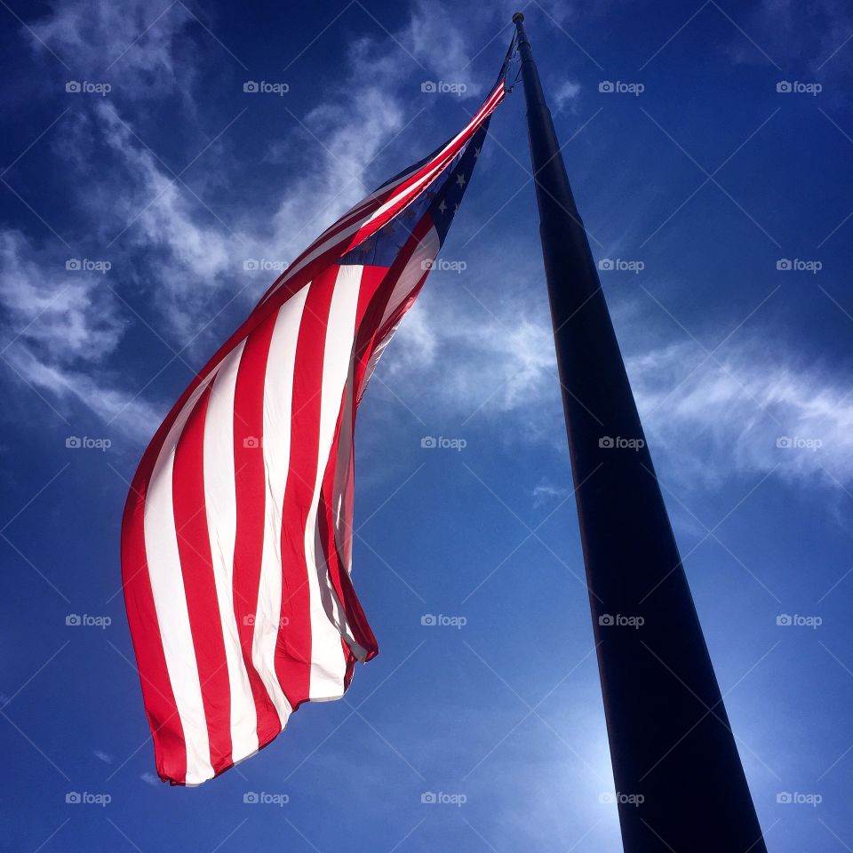 American flag. Back lit American Flag against blue sky