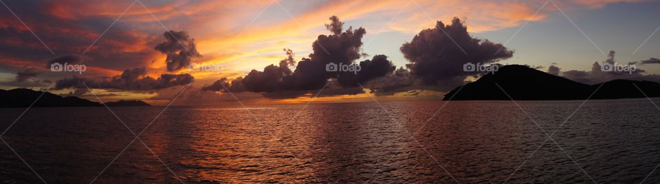 Panoramic of a sunset over water
