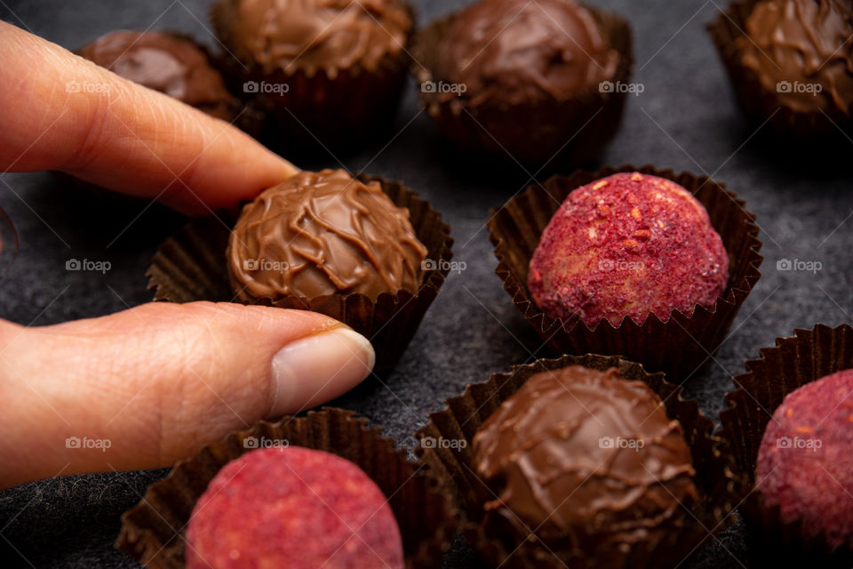 hand taking a chocolate candy