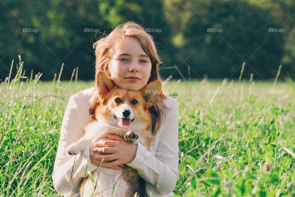 A girl with her dog on a field
