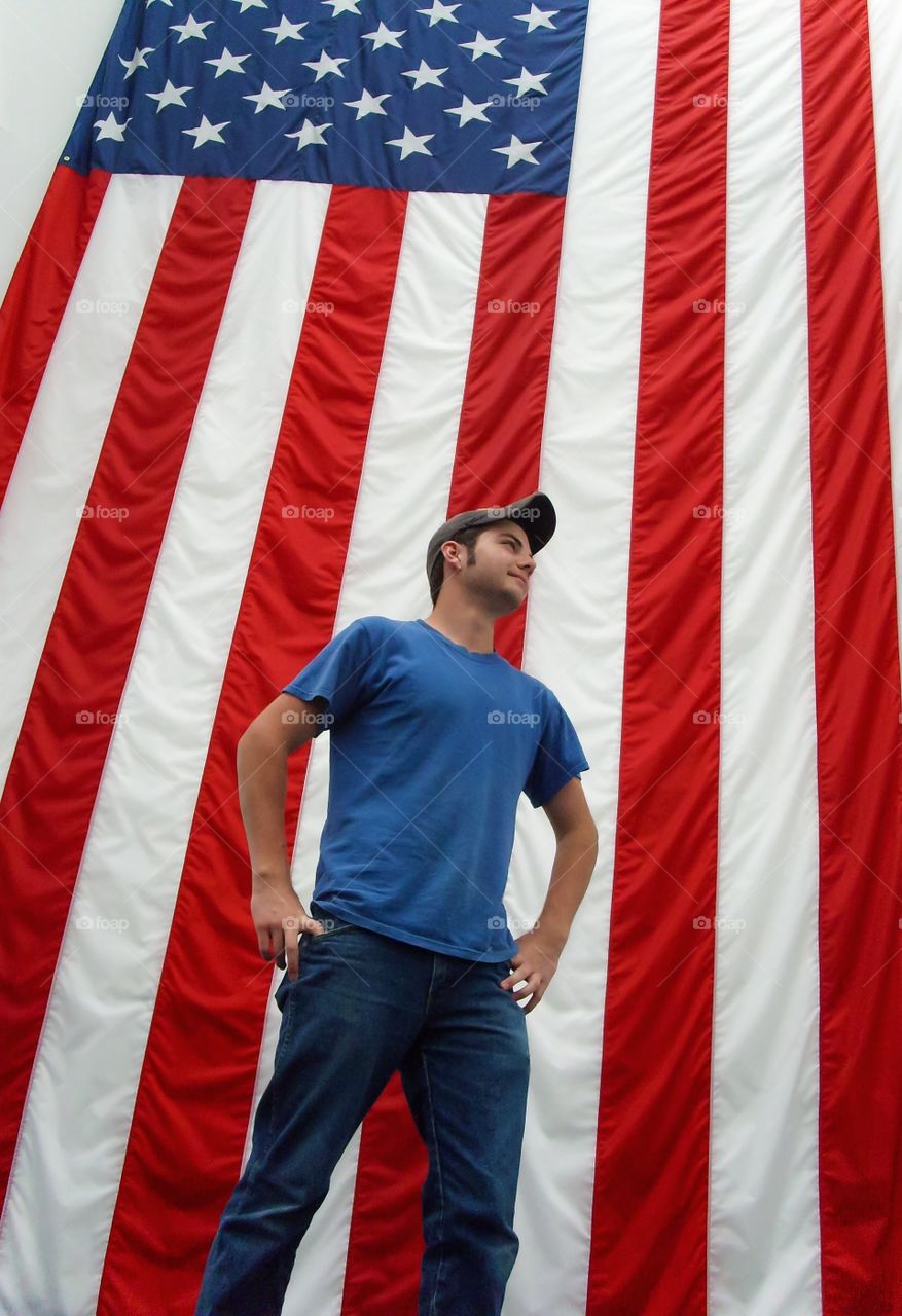 The man in front of a huge United States American flag