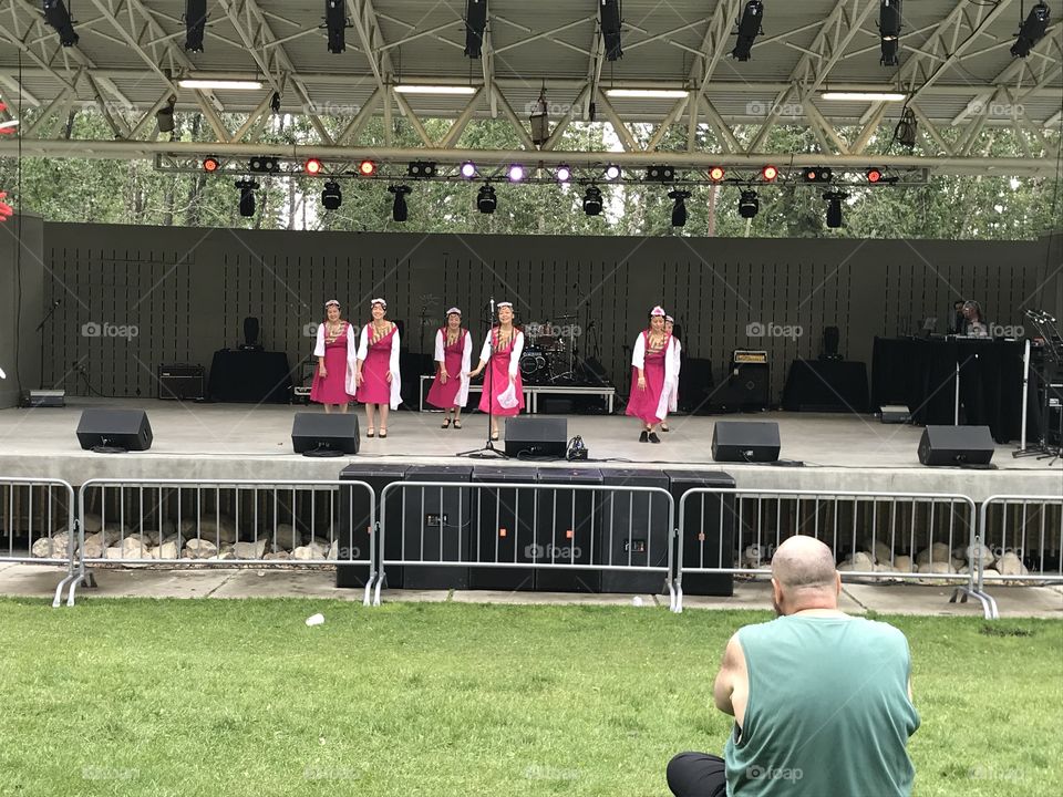 Women in red and white perform at Bower Ponds for Canada Day.