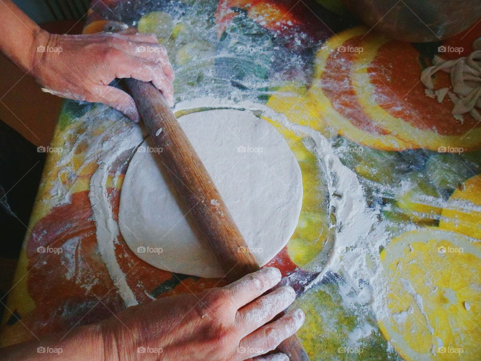 rolling out dough for delicious chebureks