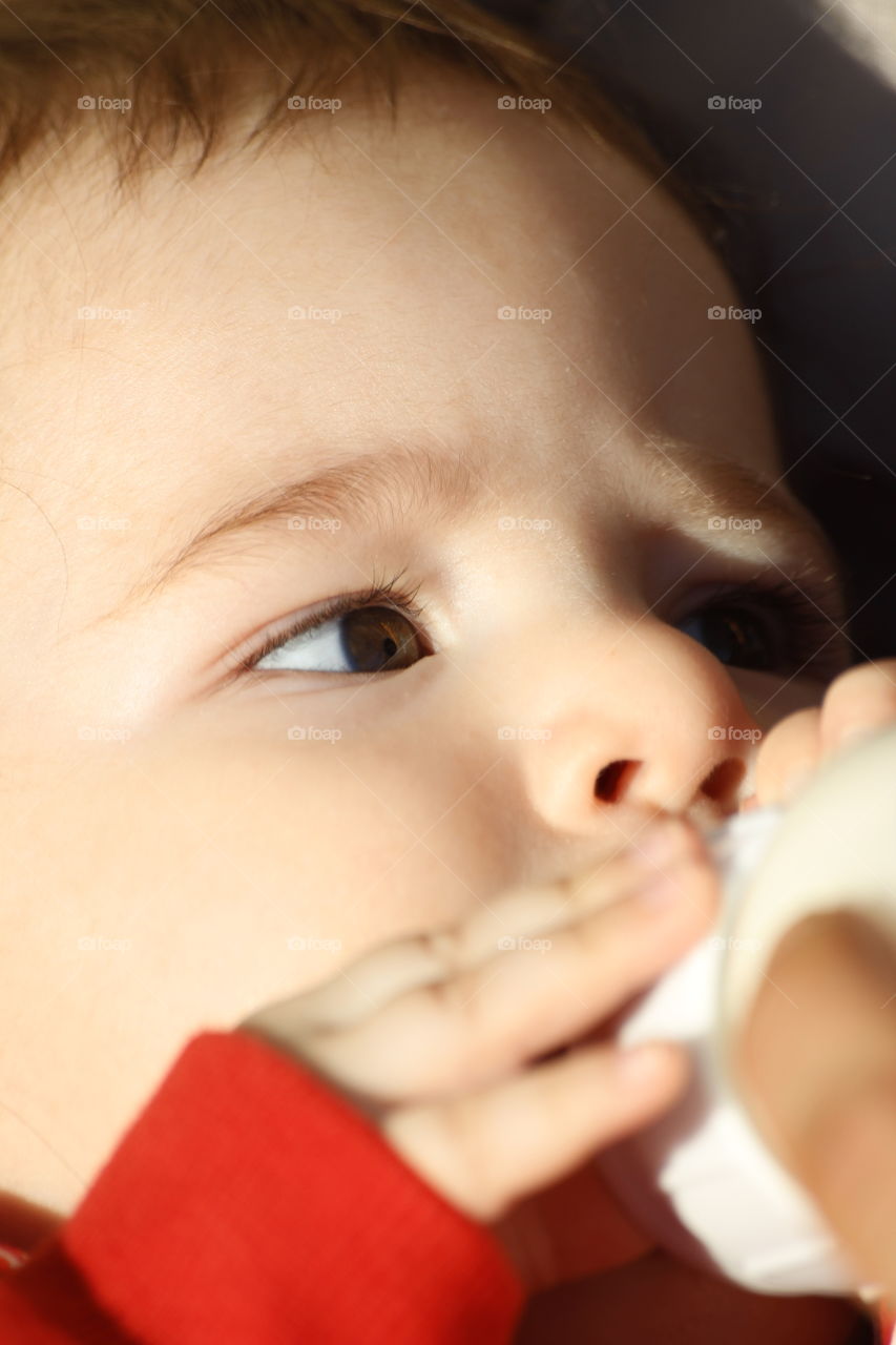 Close-up of a boy drinking milk from bottle