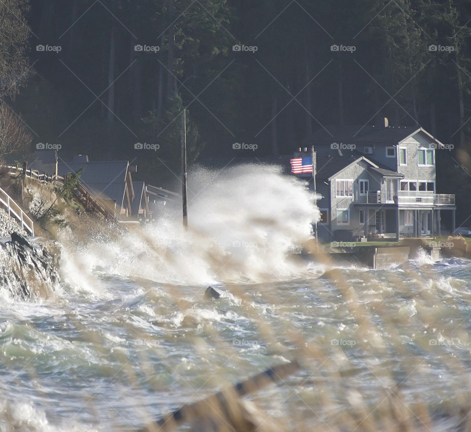 Enormous waves breaking with American flag