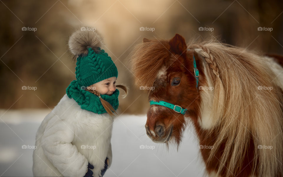 Little happy girl with pony