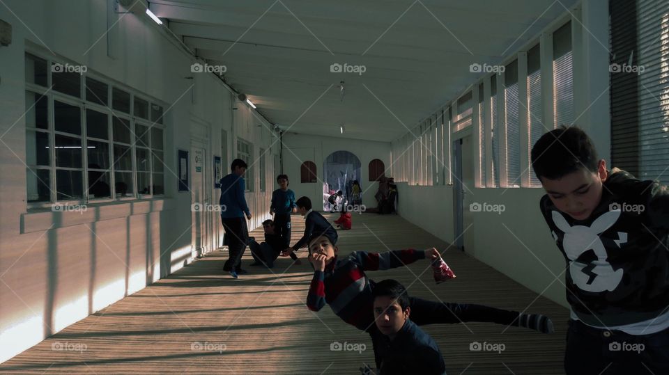 This photo was taken in a mosque that was caring for children while their parents were away. It captures the playfulness of the children and how excited they were to be photographed !