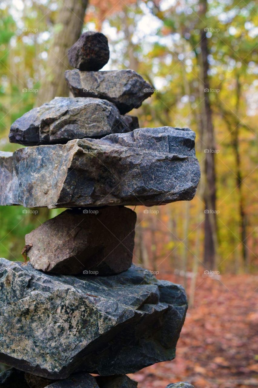 Rock balancing in woods