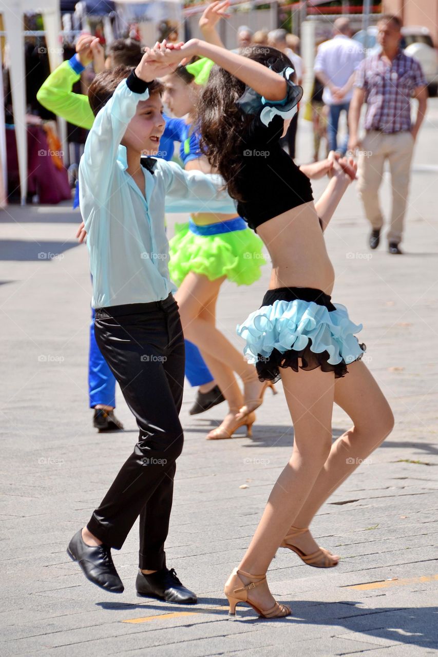 young couple dancing in the street