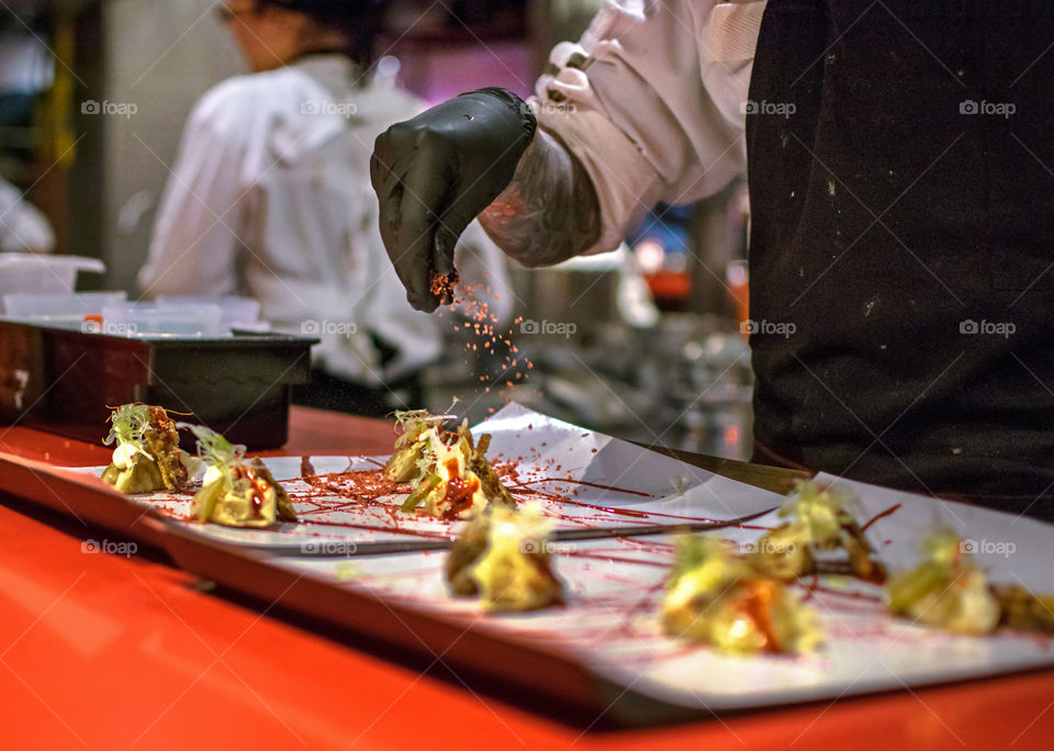 Chef seasoning dumplings at a high cuisine restaurant