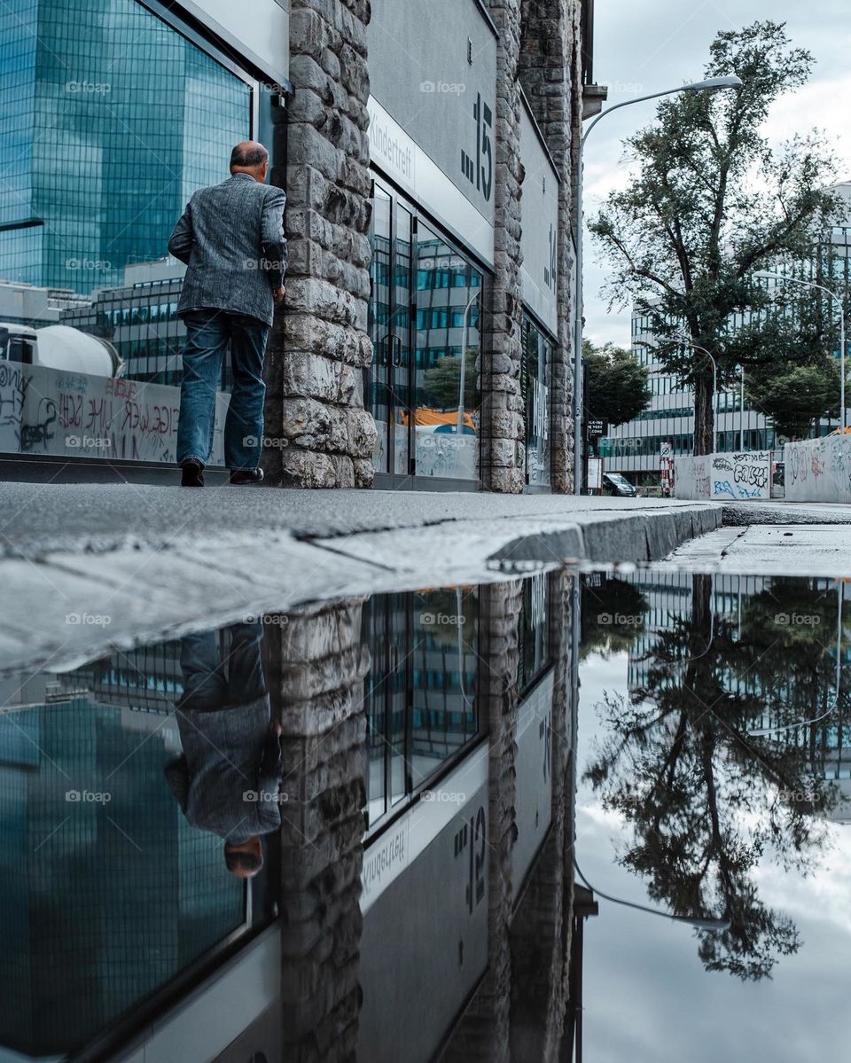 Reflection of a man in a puddle