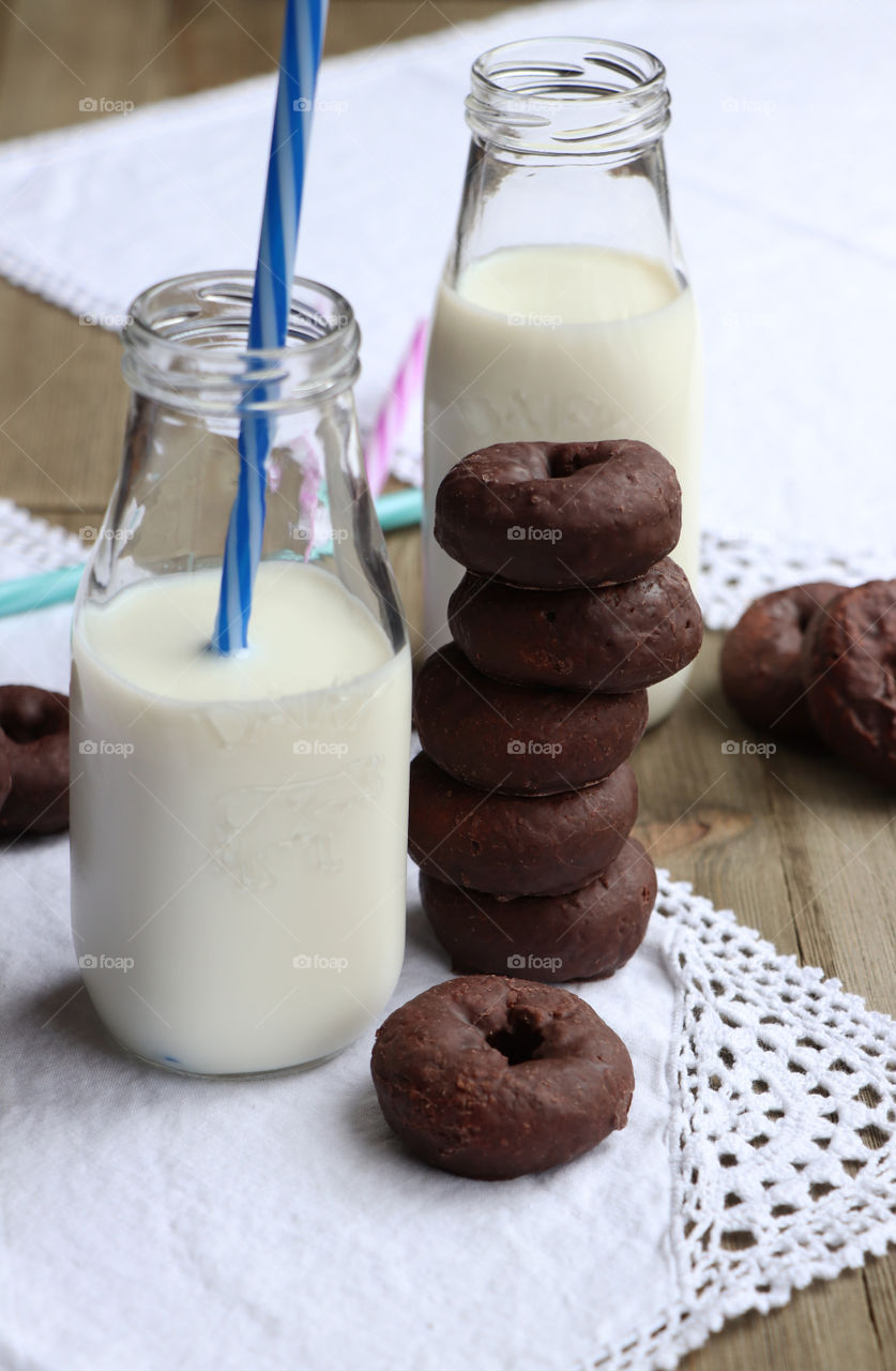 Chocolate glazed mini donuts and milk