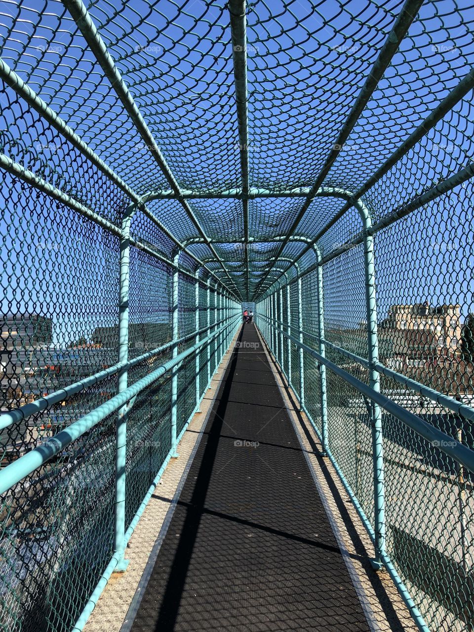 A caged overpass recedes into infinity. 