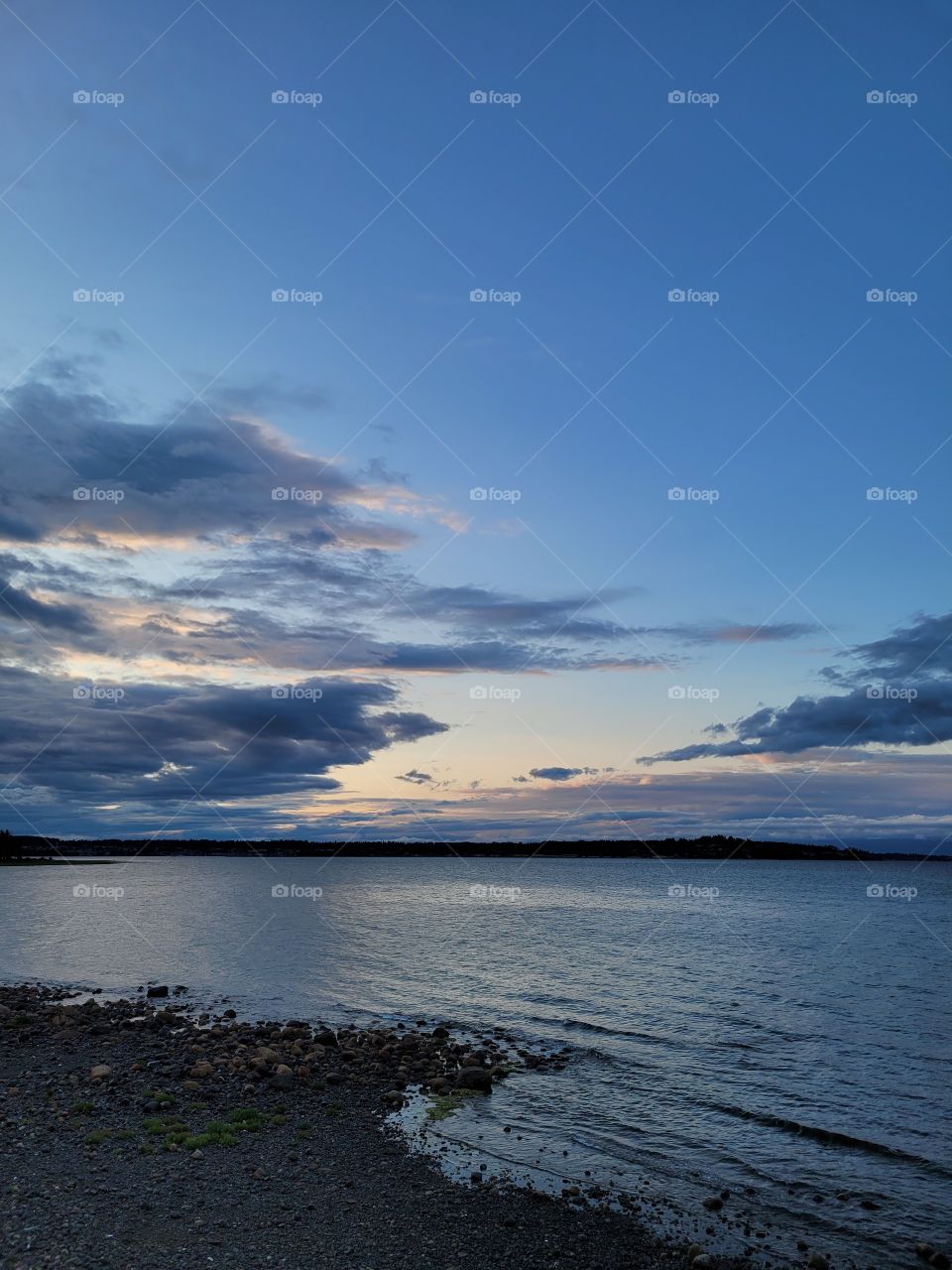 Beautiful Clouds Sunset Evening over Calm Ocean Tide in British Columbia