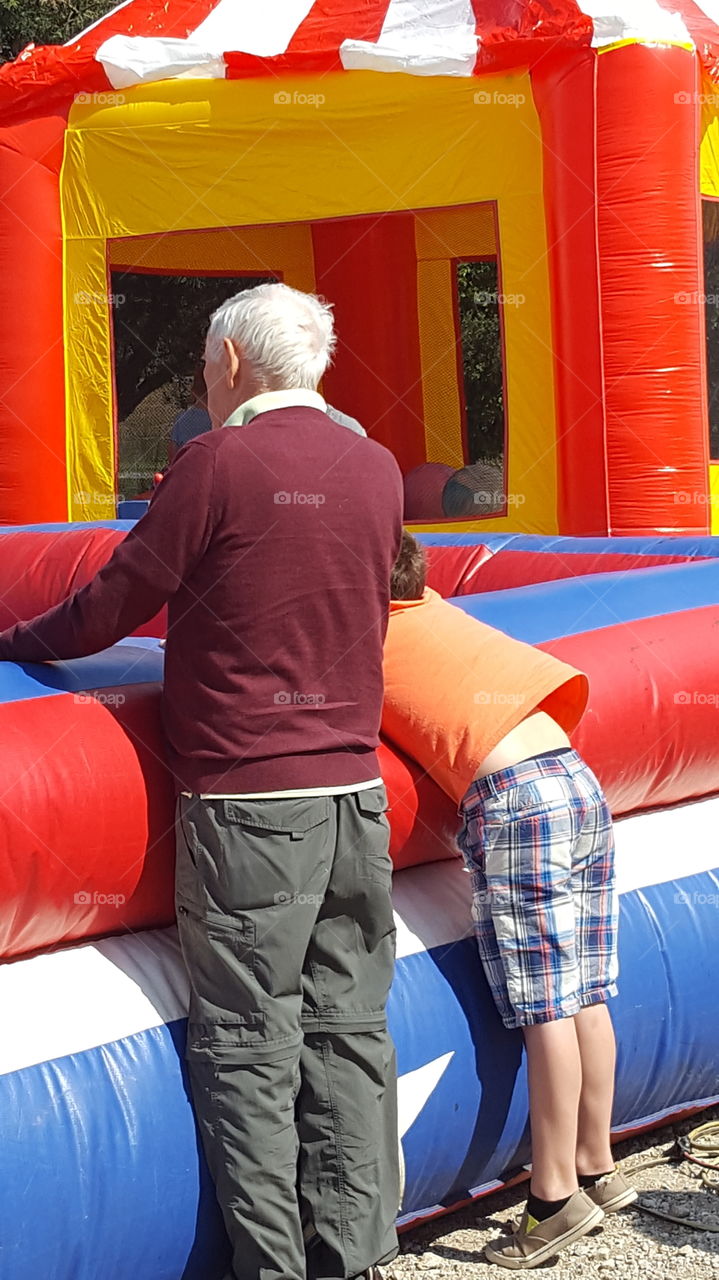 Grandpa watching mechanical bull riding.