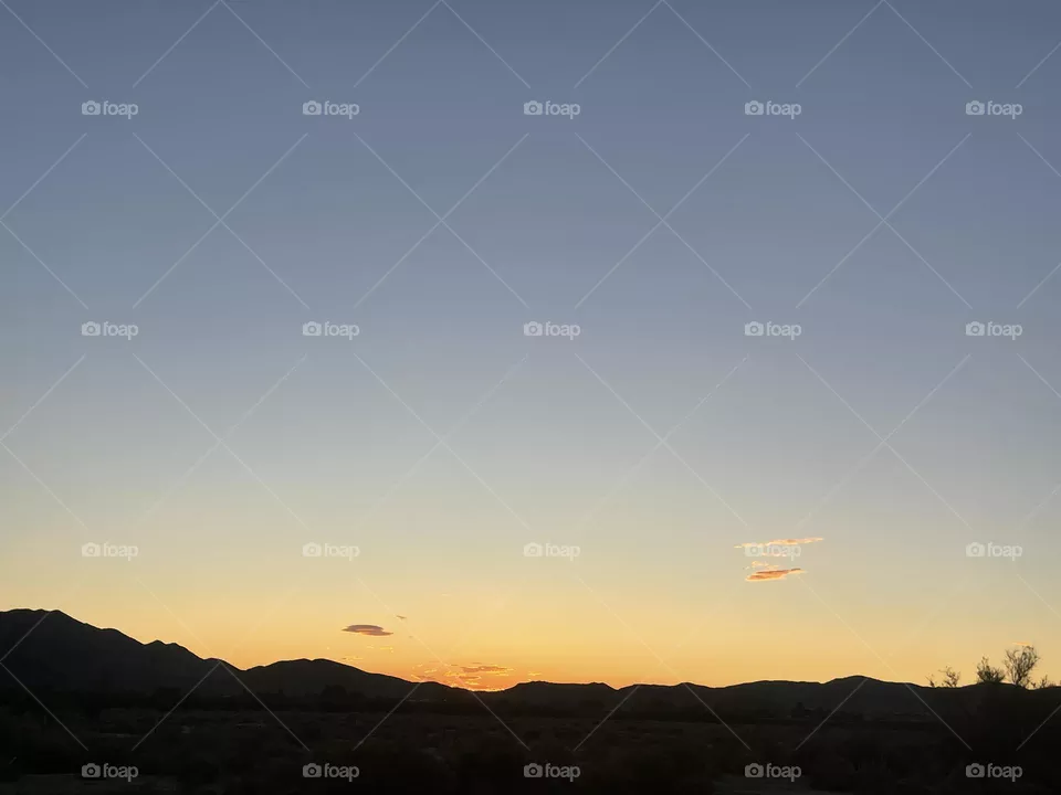 A Yellow & Orange sunset with mountains. 