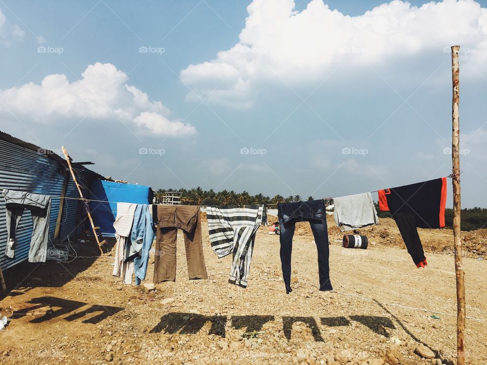 Laundry hanging on dirt road