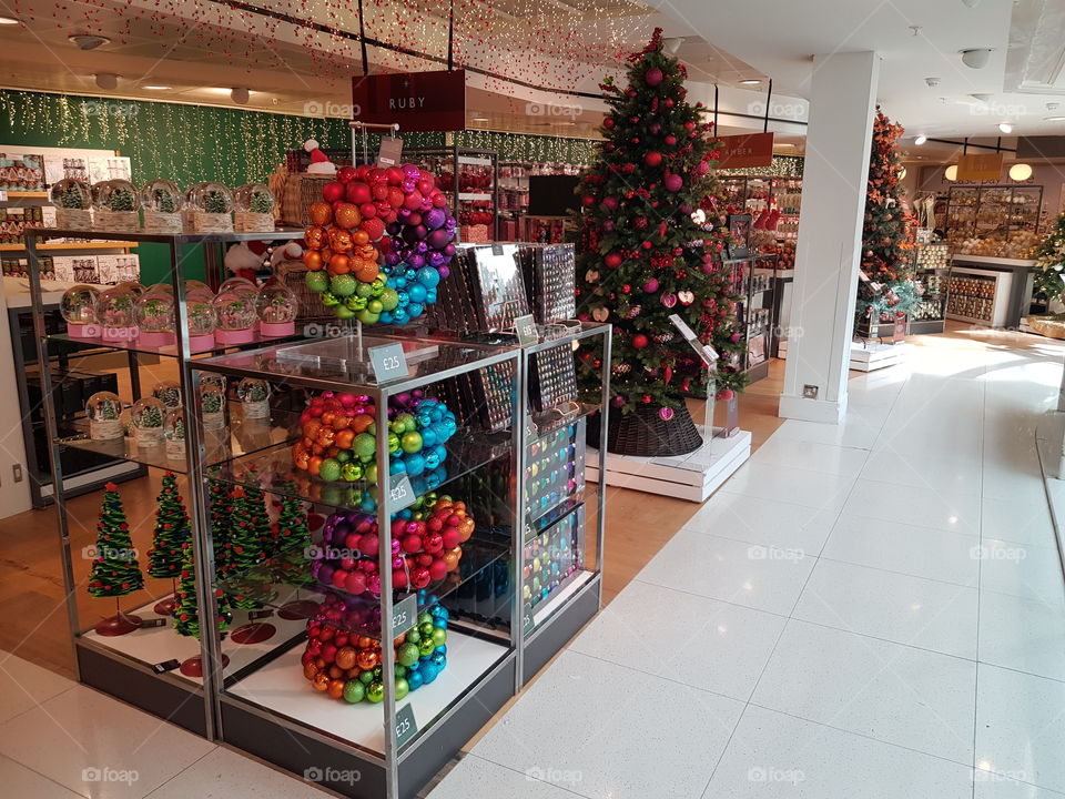 Christmas shop colourful baubles and trees at Peter Jones Sloane square Chelsea King's road London