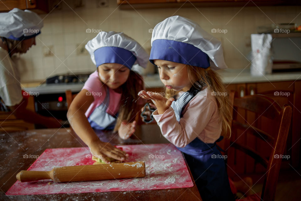 Little sisters cooking the biscuits 