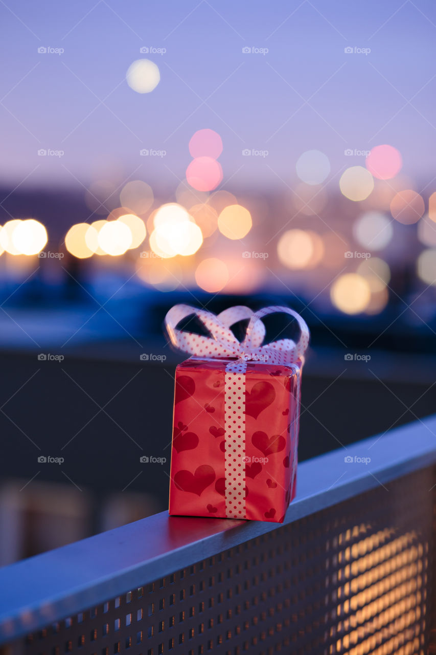 Gift box on railing of balcony