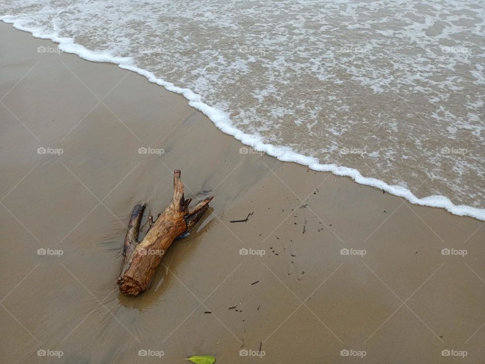 wooden piece in beach side scene of Beautiful beach waves Holliday time