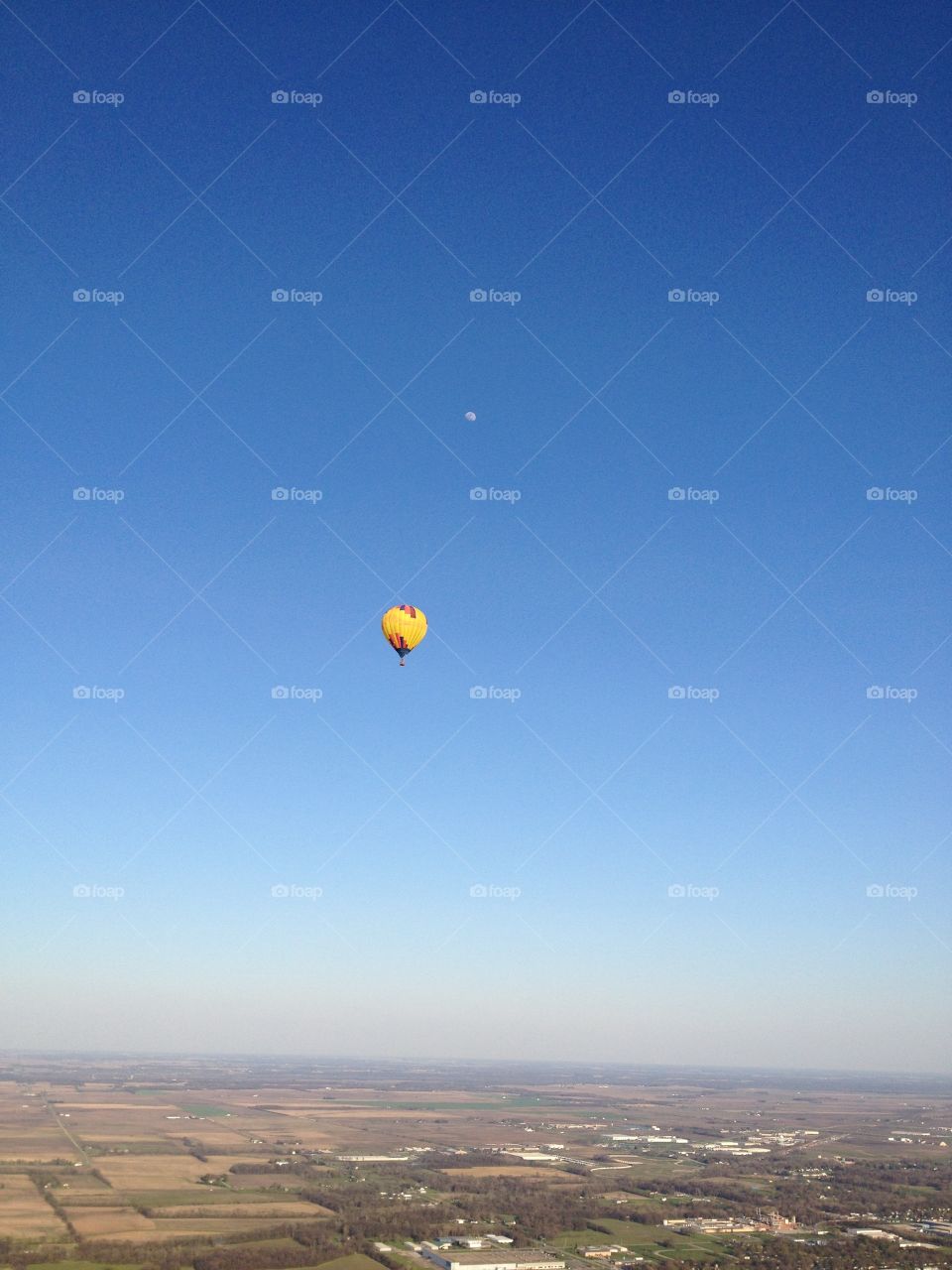 The Sun and the Moon ~ Hot air balloon Sunny Side Up captured in flight with the moon