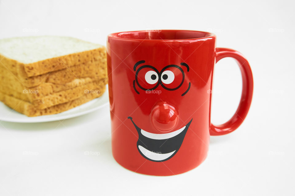 Coffee cup and bread on gray background 