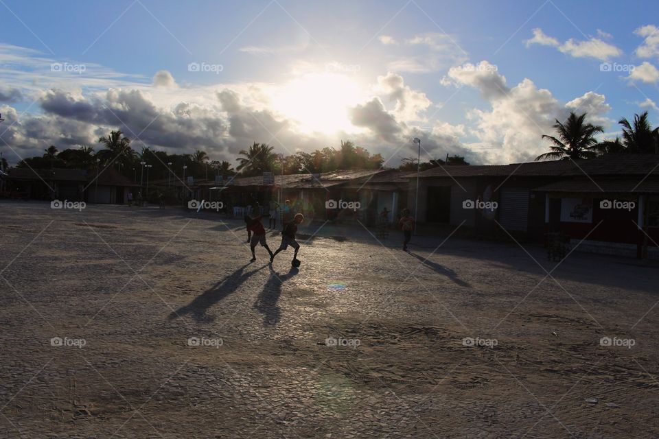 Children of a village playing football on the street