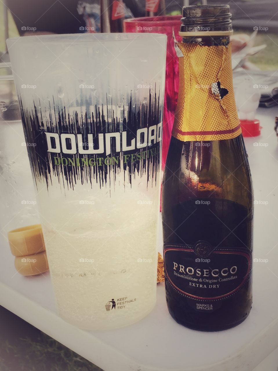 A bottle of prosecco next to a recyclable cup at Download festival Donnington England 