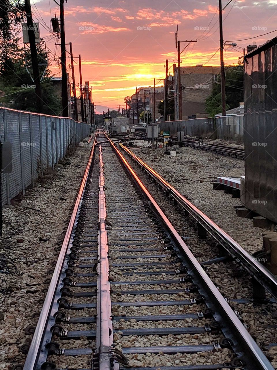 beautiful sunset reflecting off train tracks