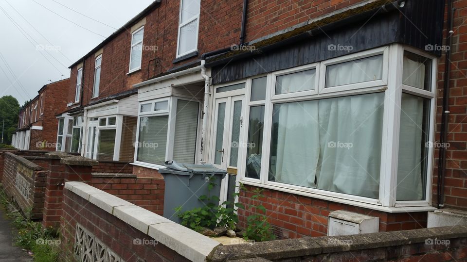 A row of terraced houses.
A terraced or terrace house (UK) or townhouse (US) is a term in architecture and city planning referring to a style of medium-density housing that originated in Europe in the 16th century, where a row of identical or mirror-image houses share side walls. They are also known in some areas as row houses or linked houses.