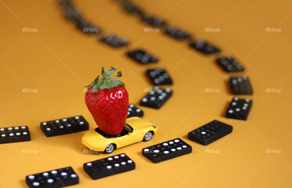 Strawberry on the road of domino