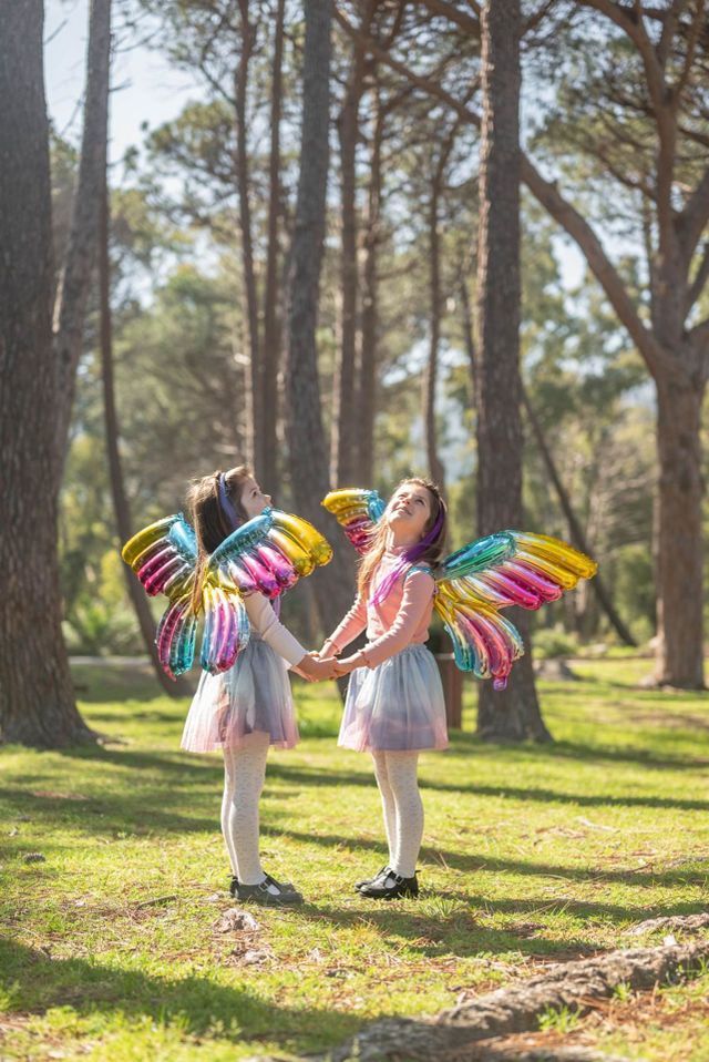 Girls in the spring forest, two butterfly girls in the forest, girls looking at the sky