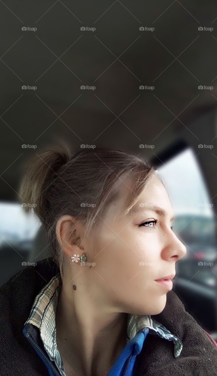 woman looking out the window on a rainy day
