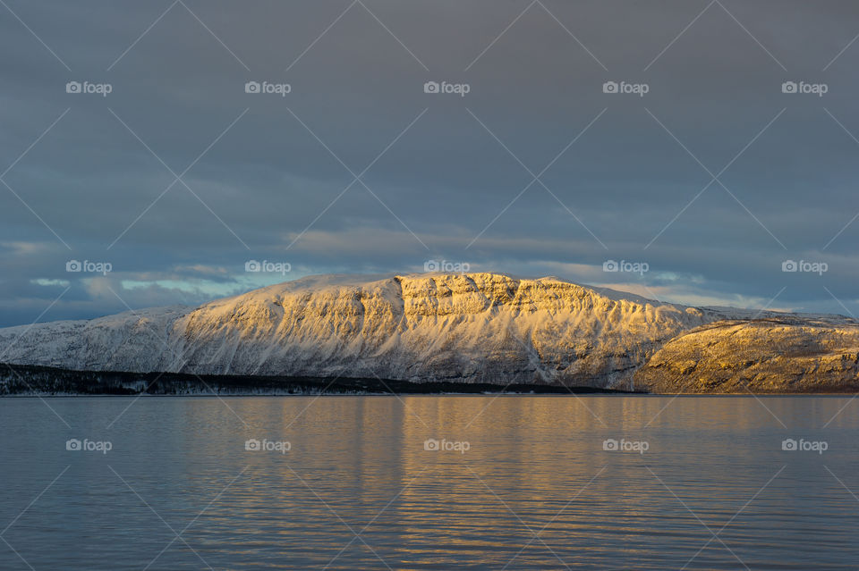 Snowcovered mountain near the idyllic lake