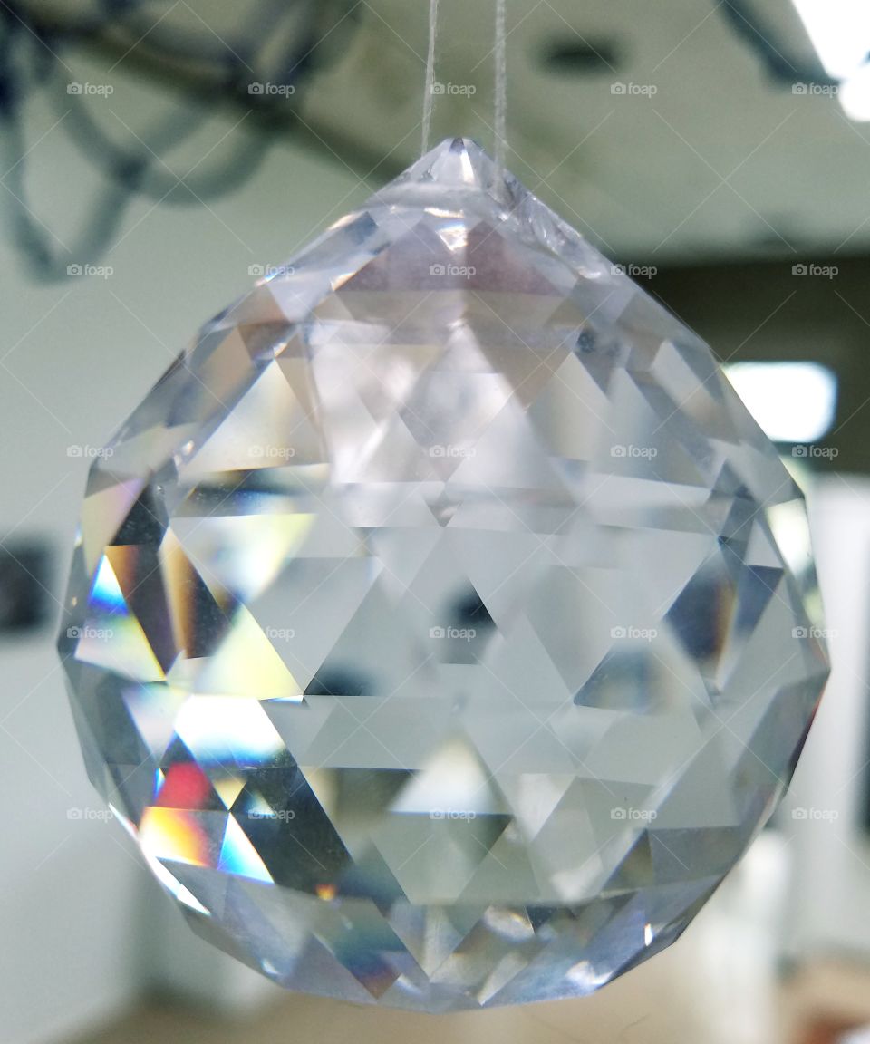 close up of hanging crystal prism, light refraction
