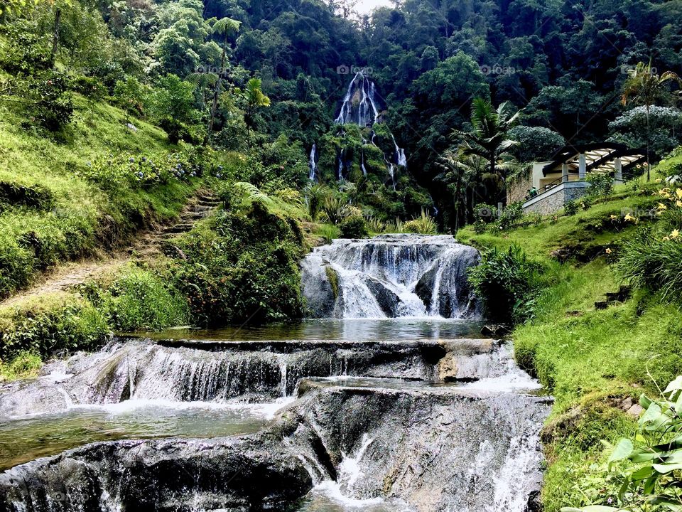 Some small waterfalls surrounded by vegetation.  Relaxing and beautiful place in Colombia